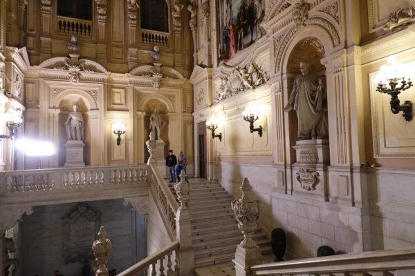 The staircase of the Royal Palace of Turin was constructed by Benedetto Alfieri as an access to offices of state. Sculptures of Spanish royalty stand proudly in apses and look out upon visitors in the towering space. Subtle shades of yellow and pale pink climb the walls that are richly layered with paneling, creating added dimension at each level.  (Guilhem Vellut/CC BY 2.0)