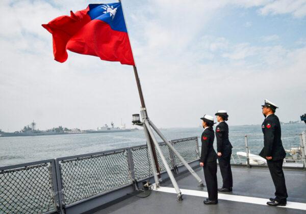Taiwanese sailors salute the island's flag on the deck of the Panshih supply ship after taking part in annual drills at the Tsoying naval base in Kaohsiung, Taiwan, on Jan. 31, 2018. (Mandy Cheng/AFP via Getty Images)