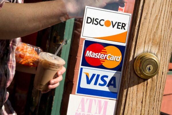A coffee shop displays signs for Visa, MasterCard and Discover, in Washington, on May 1, 2013. (Jonathan Ernst/Reuters)
