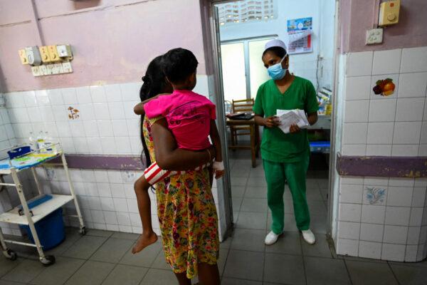 A mother with her child speaks with a nurse in Lady Ridgeway Hospital for Children in Colombo, Sri Lanka, on April 21, 2022. Sri Lanka used to import about 85 percent of its pharmaceutical supplies, but is suffering its worst economic crisis since 1948. (Ishara S. Kodikara/AFP via Getty Images)