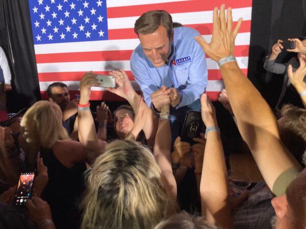 Nevada Republican U.S. Senate candidate Adam Laxalt shakes hands with supporters during a rally at Stoney's Rockin' Country in Las Vegas, on June 10, 2022. (John Haughey/The Epoch Times)