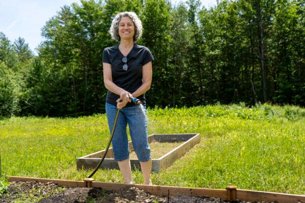 New Hampshire Free State Project participant Jody Underwood tends her garden on her off-grid property in Croydon, N.H. (Neil Sheehan/The Epoch Times)