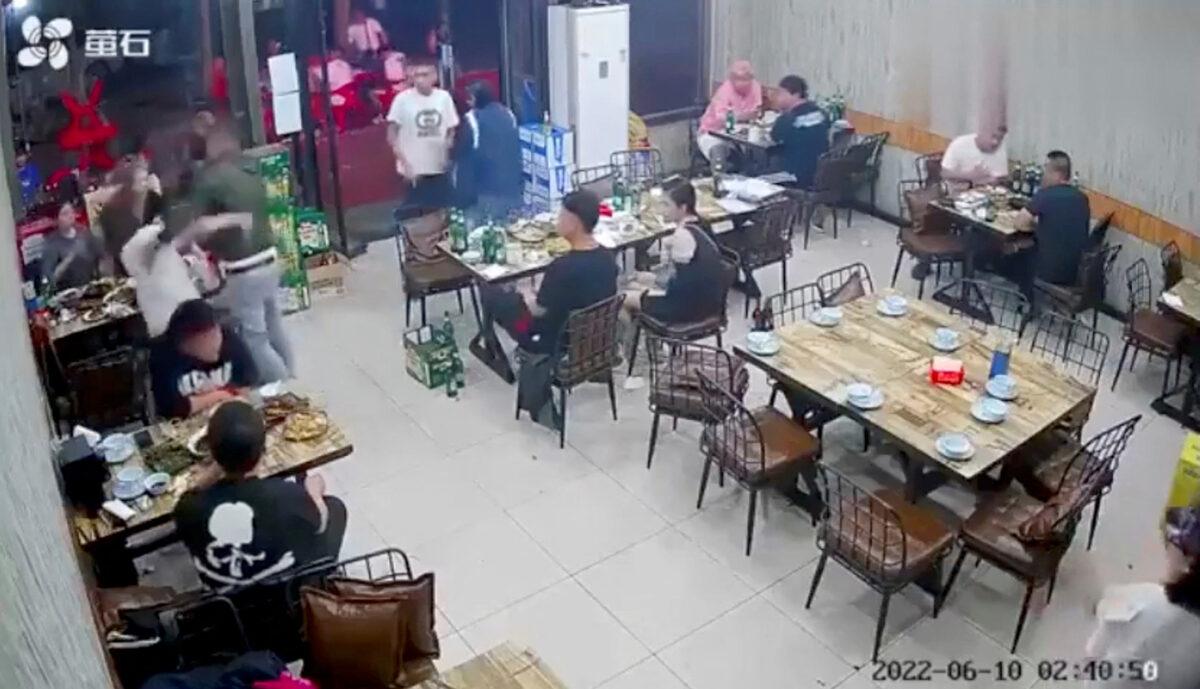 A man assaults a woman at a restaurant in the northeastern city of Tangshan, China, on June 10, 2022, in this screen grab taken from surveillance footage obtained by Reuters. (Reuters)