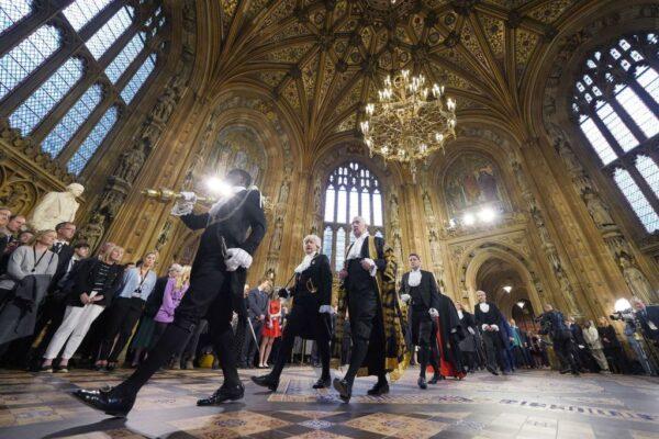 Serjeant-at-Arms Ugbana Oyet (L) carries the mace from the Commons chamber across through the Central Lobby, followed by Speaker of the Commons, Lindsay Hoyle (C) and Lady Usher of the Black Rod, Sarah Clarke, during the State Opening of Parliament, at the Houses of Parliament, in London, England, on May 10, 2022. (Yui Mok/Pool/AFP via Getty Images)
