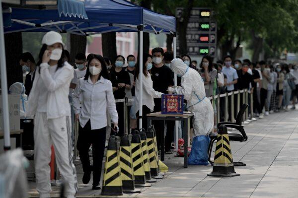 People line up at a swab collection site to test for COVID-19 in Beijing on June 13, 2022. (NOEL CELIS/AFP via Getty Images)