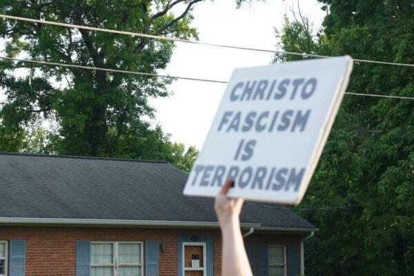 A pro-abortion protester holds a sign reading "Christo Fascism is Terrorism" as she marches to Supreme Court Justice Samuel Alito's neighborhood in Fairfax, Va., on June 13, 2022. (Jackson Elliott/The Epoch Times)