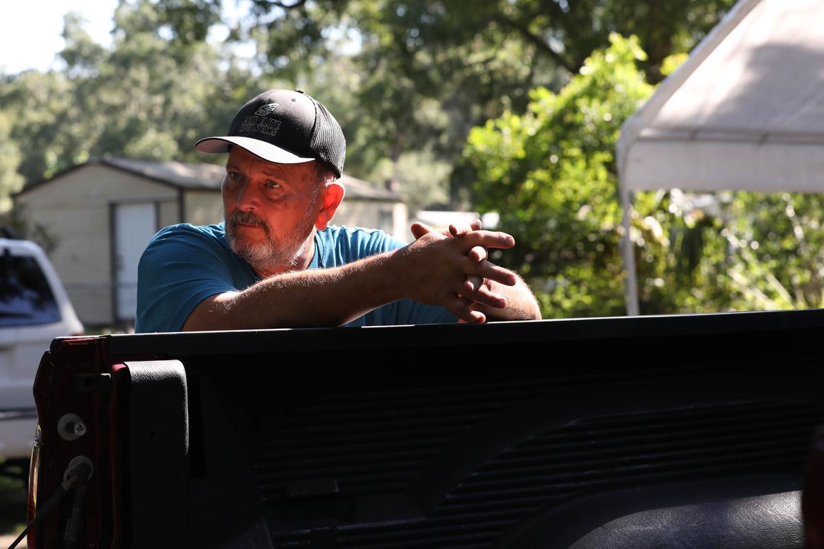 Gary Cananzey observes as archaeologist Rachel Kangas identifies artifacts found on Cananzey's nephew's property. (Angelica Edwards/Tampa Bay Times/TNS)