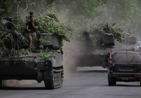 Ukrainian servicemen ride American 155 mm turreted self-propelled howitzers M109 in Donetsk region, Ukraine, on June 13, 2022. (Gleb Garanich/Reuters)