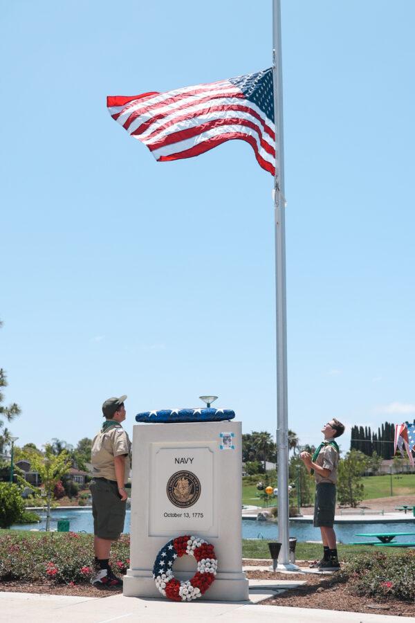 Boy Scout Troop 628 raises the American flag at a celebration for Flag Day at Veterans Park in Lake Forest, Calif., on June 14, 2022. (Julianne Foster/The Epoch Times)
