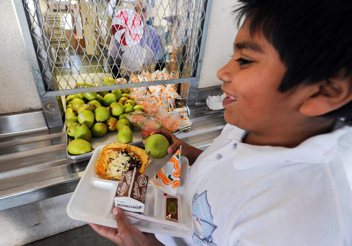 A cafeteria worker supervises lunches for schoolchildren at the Normandie Avenue Elementary School in South Central Los Angeles, Calif., on Dec. 2, 2010. (Mark Ralston/AFP/Getty Images)