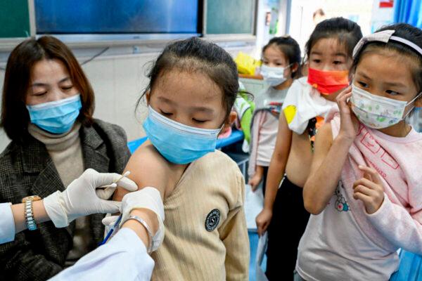 A child receives COVID-19 vaccine at a school in Handan, in China's Hebei Province, on Oct. 27, 2021, after the city began vaccinating children from the ages of 3 to 11. (-/AFP via Getty Images)
