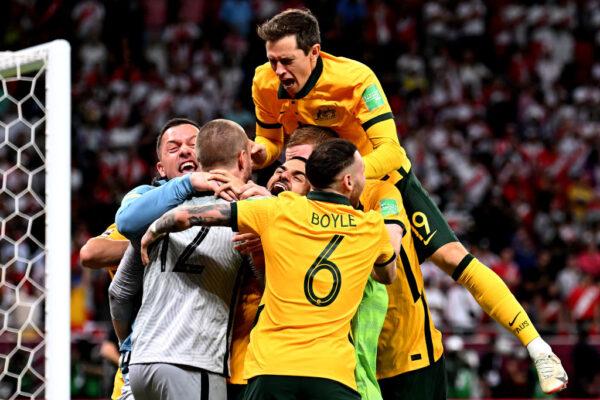 The Socceroos gather around keeper Andrew Redmayne after defeating Peru in the 2022 FIFA World Cup Playoff match in Doha, Qatar, on June 13, 2022. (Photo by Joe Allison/Getty Images)
