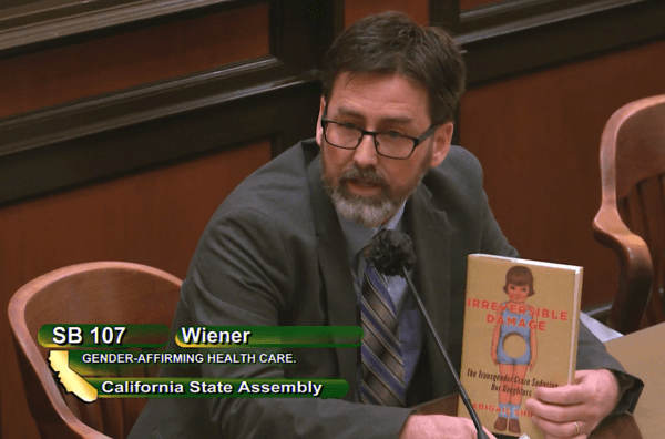 Greg Burt of the California Family Council holds up a copy of Abigail Shrier’s book “Irreversible Damage” at a California Assembly Judiciary Committee hearing in Sacramento, Calif., on June 8, 2022. (Screenshot via California State Assembly)