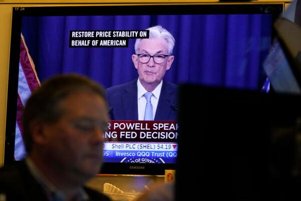 Federal Reserve Chairman Jerome Powell news conference on televisions while traders work on the floor at the New York Stock Exchange in New York on June 15, 2022. (Seth Wenig/AP Photo)