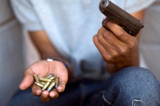 <br/>A young gang member shows a gun and ammunition, in Cape Town, in file photo from 2012. Cape Town's murder rate is 62 in every 100,000 people, the highest in the world. (Rodger Bosch/AFP via Getty Images)