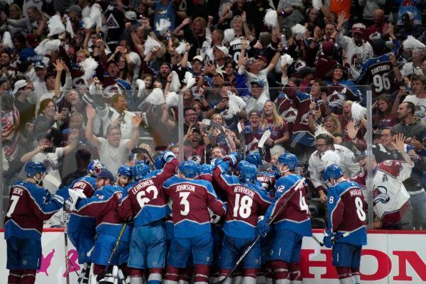 The Colorado Avalanche celebrate after an overtime win over the Tampa Bay Lightning in Game 1 of the NHL hockey Stanley Cup Final in Denver on June 15, 2022. (John Locher/AP Photo)
