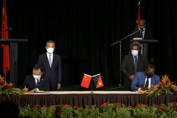 Chinese Foreign Minister Wang Yi (Back row left) with his Papua New Guinea's counterpart Soroi Marepo Eoe (back row right) witness agreements signing between the two countries in Port Moresby on June 3, 2022. (Andrew Kutan/AFP via Getty Images)