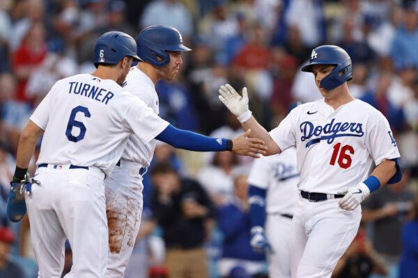 Will Smith #16 of the Los Angeles Dodgers celebrates with teammates Trea Turner #6 and Freddie Freeman #5 after hitting a three-run home run against the Los Angeles Angels during the first inning at Dodger Stadium, in Los Angeles, on June 15, 2022. (Michael Owens/Getty Images)