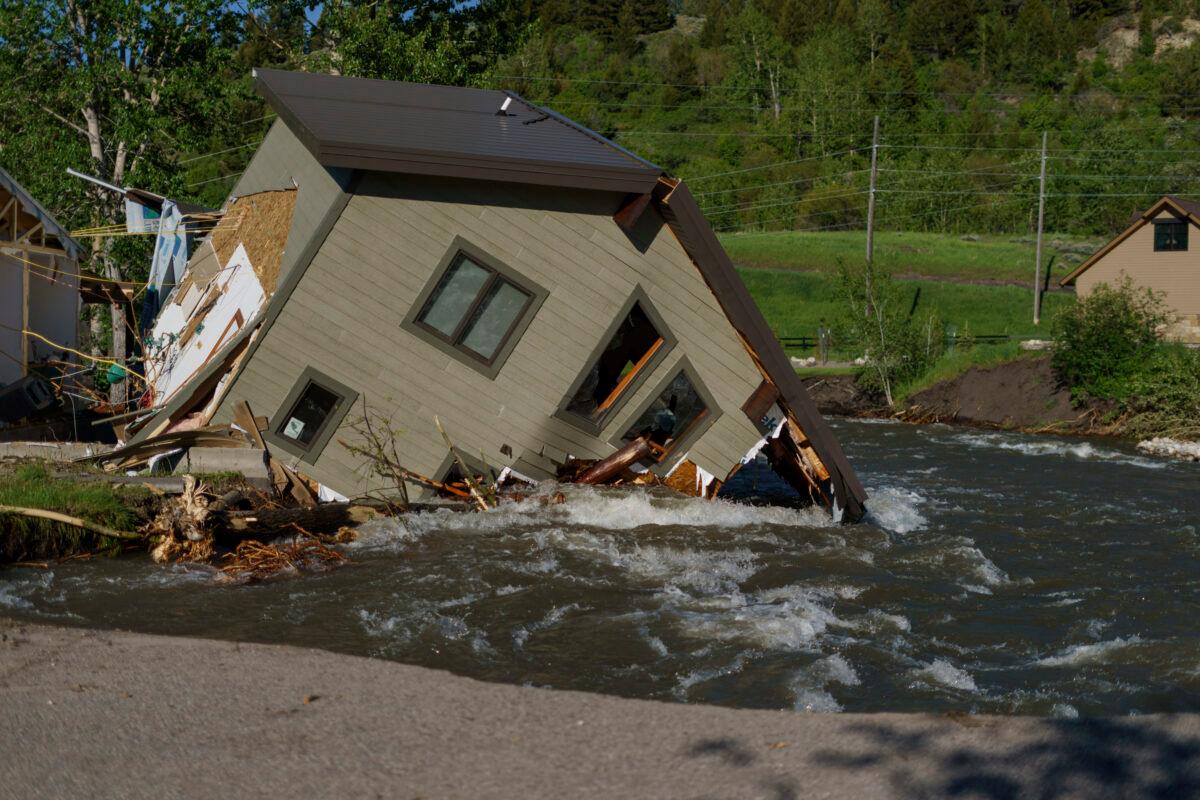 A house sits in Rock Creek after floodwaters washed away a road and a bridge in Red Lodge, Mont., on June 15, 2022. (David Goldman/AP Photo)