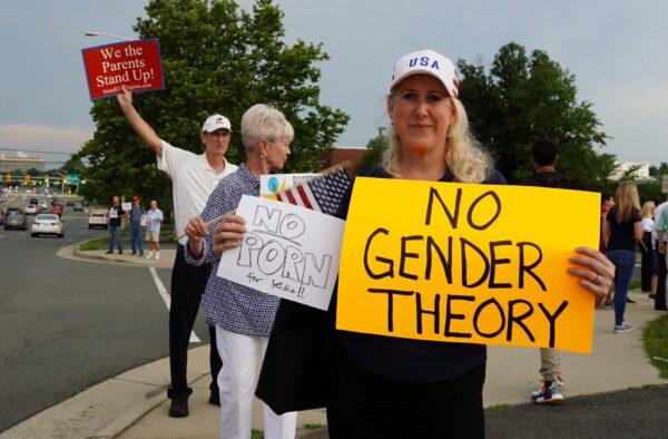 Jean Ballard (C) protests Fairfax County school board’s pro-transgender policy outside of the Luther Jackson Middle School in Falls Church, Va., on June 16, 2022. (Terri Wu/The Epoch Times)