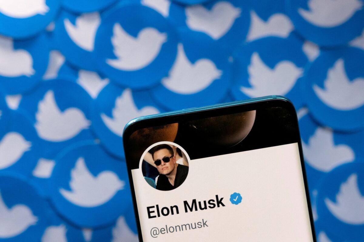 Elon Musk's Twitter profile on a smartphone is placed on printed Twitter logos in this picture illustration taken on April 28, 2022. (Dado Ruvic/Reuters)