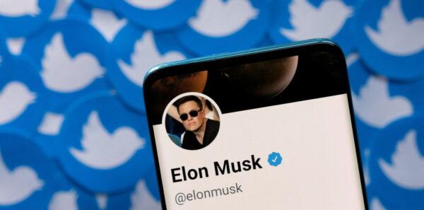Elon Musk's Twitter profile on a smartphone placed on printed Twitter logos in this picture illustration taken on April 28, 2022. (Dado Ruvic/Reuters)