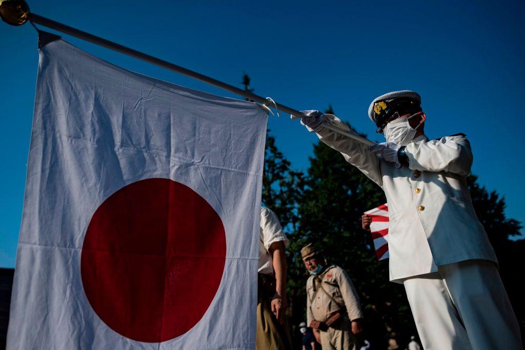 Men wearing period Japanese Imperial Army and Navy uniform gather outside the Yasukuni shrine in Tokyo on August 15, 2020, on the 75th anniversary of Japan's surrender in World War II. (Philip Fong/AFP via Getty Images)