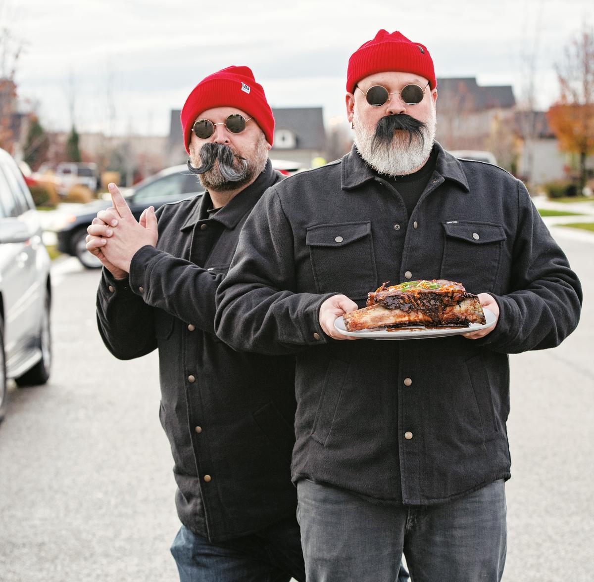 Mark Anderson (L) and Ryan Fey, The Grill Dads, are longtime friends who turned their love for grilling into culinary stardom. Among their smoke-kissed creations are internationally inspired dishes, such as their take on Korean BBQ beef ribs (featured in the "International Men of Mystery" chapter of their cookbook). (Ken Goodman)