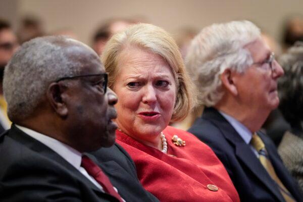 Ginni Thomas, center, speaks to Supreme Court Justice Clarence Thomas during an event in Washington on Oct. 21, 2021. (Drew Angerer/Getty Images)