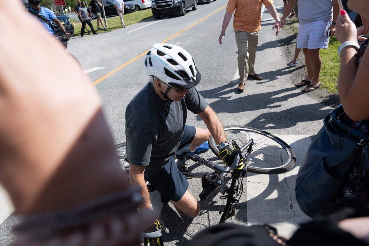 President Joe Biden falls off his bicycle following a bike ride in Rehoboth Beach, Delaware, on June 18, 2022. (Saul Loeb/AFP/Getty Images)