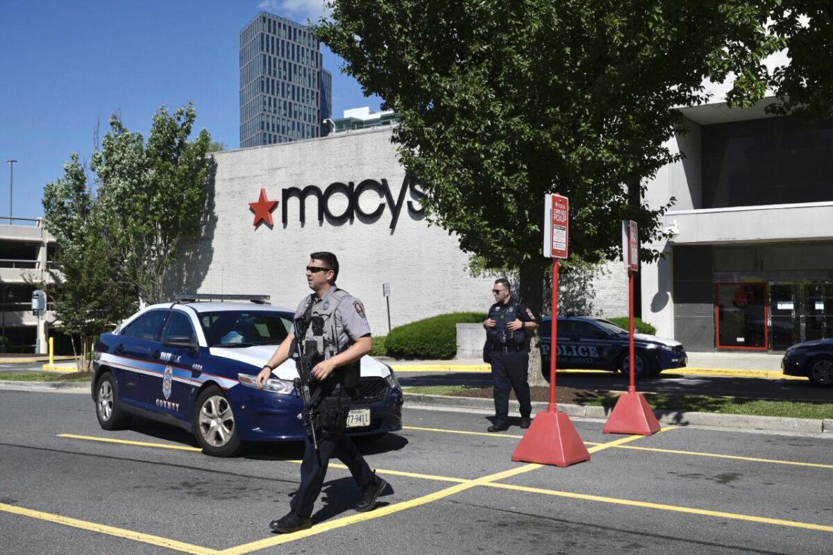 Police stand outside a Macy's department store at Tysons Corner Mall in Tysons Corner, Va., on June 18, 2022. (Craig Hudson/The Washington Post via AP)