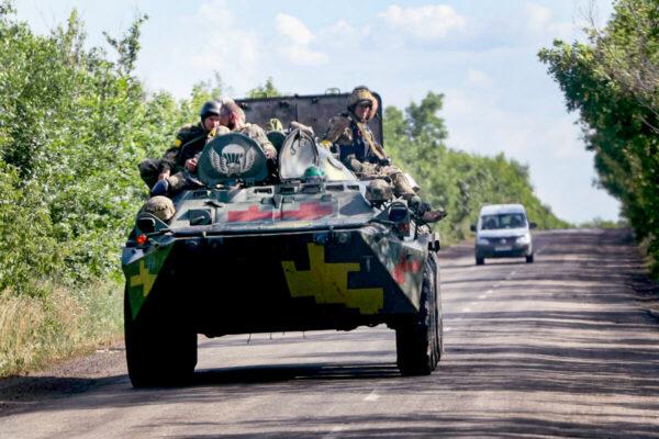 Troops ride on a military vehicle near Lysychansk, Ukraine, on June 16, 2022. (Scott Olson/Getty Images)