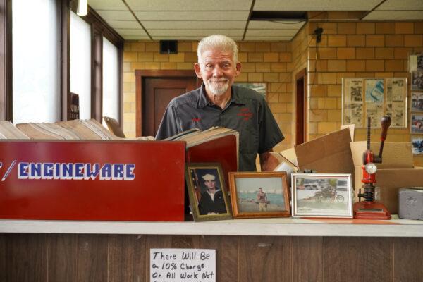 John Shotts stands in his auto repair business office in Galesburg, Ill., on June 7, 2022. (Cara Ding/The Epoch Times)