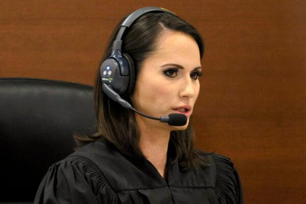 Judge Elizabeth Scherer participates in a sidebar discussion via headset during jury selection in the penalty phase of the trial of Marjory Stoneman Douglas High School shooter Nikolas Cruz at the Broward County Courthouse in Fort Lauderdale, Fla., on June 22, 2022. (Amy Beth Bennett/South Florida Sun Sentinel via AP, Pool)