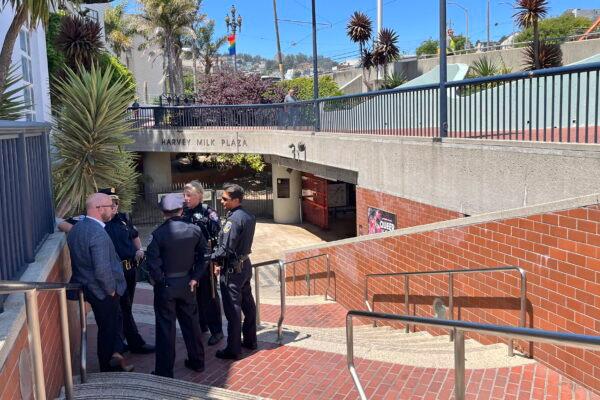 Police personnel confer with San Francisco Supervisor Rafael Mandelman (L) outside the entrance to the Castro Muni Metro station following a shooting in San Francisco on June 22, 2022. (Janie Har/AP Photo)