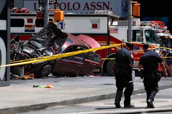 A smashed car sits on the corner of Broadway and 45th Street in Times Square, New York, on May 18, 2017, after the car was driven into a crowd of pedestrians. (Seth Wenig/AP Photo)