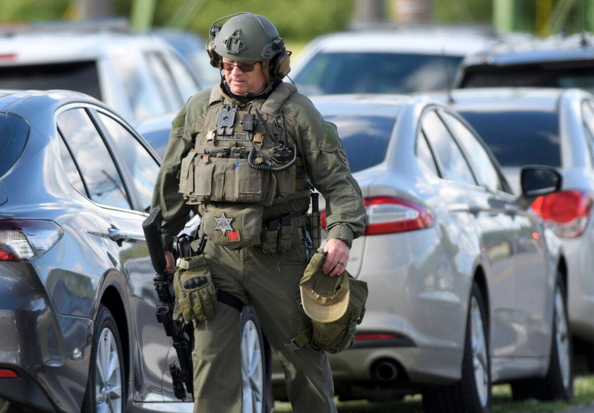 A tactical police officer walks near where a man killed three people when he opened fire at a business in Smithsburg, Md., on June 9, 2022. (Steve Ruark/AP Photo)
