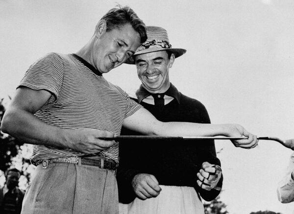 Lew Worsham (L), takes a good look at the putter that Sam Snead, right, used to sink a 20-foot putt on the last hole to force a playoff in the U.S. Open golf tournament at St. Louis Country Club in Ladue, Mo. on June 14, 1947. (AP Photo)