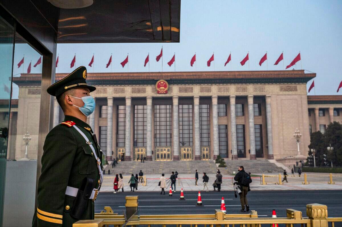 A police officer stands guard outside the Great Hall of the People in Beijing on March 10, 2022. (Kevin Frayer/Getty Images)
