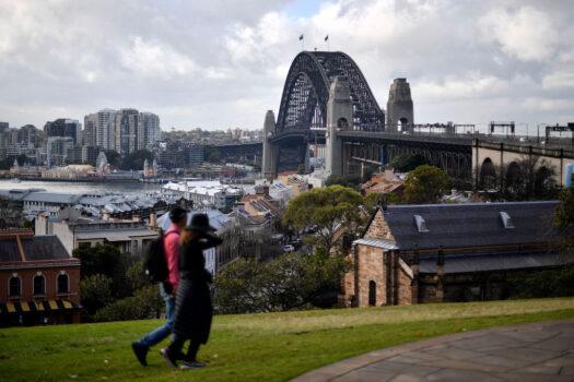 A couple visit a tourist area overlooking the Harbour Bridge in Sydney, Australia on June 28, 2021. (Saeed Khan/AFP via Getty Images)