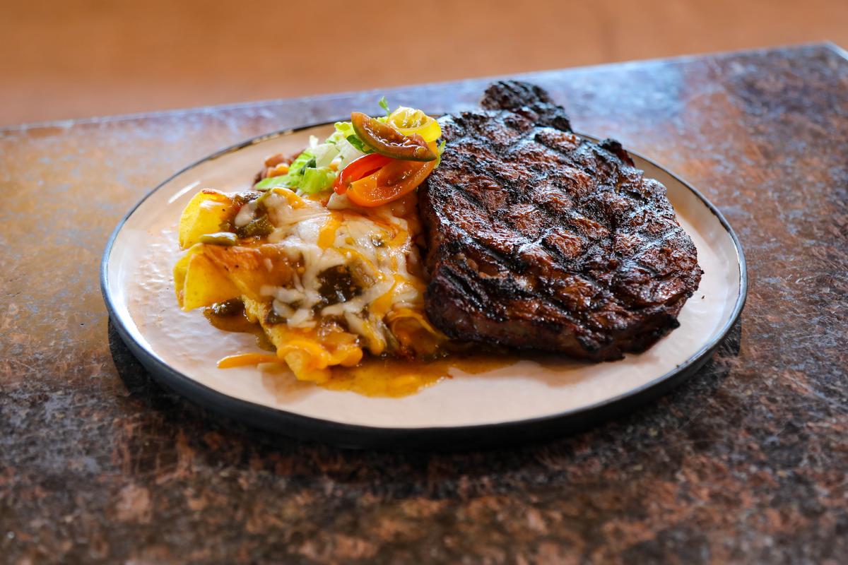 The restaurant uses beef raised by Native American ranchers, for dishes like the hand-cut ribeye served with rolled enchiladas, red or green chile, melted cheese, and Pueblo beans. (Courtesy of the Indian Pueblo Cultural Center)