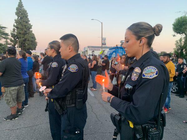 In honor of two El Monte police officers killed in a recent motel shooting, more than a thousand community members, law enforcement officers, and family members gathered at a candlelight vigil outside the El Monte Civic Center in El Monte, Calif., on June 18, 2022. (Linda Jiang/The Epoch Times)