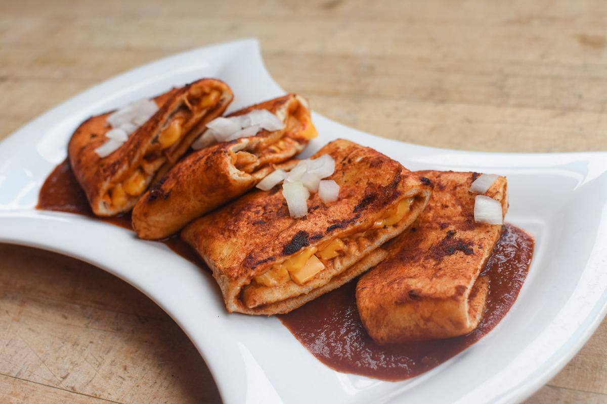 The Jemez enchilada layers a housemade flour tortilla with red chile, American cheese, and diced onion. (Courtesy of the Indian Pueblo Cultural Center)