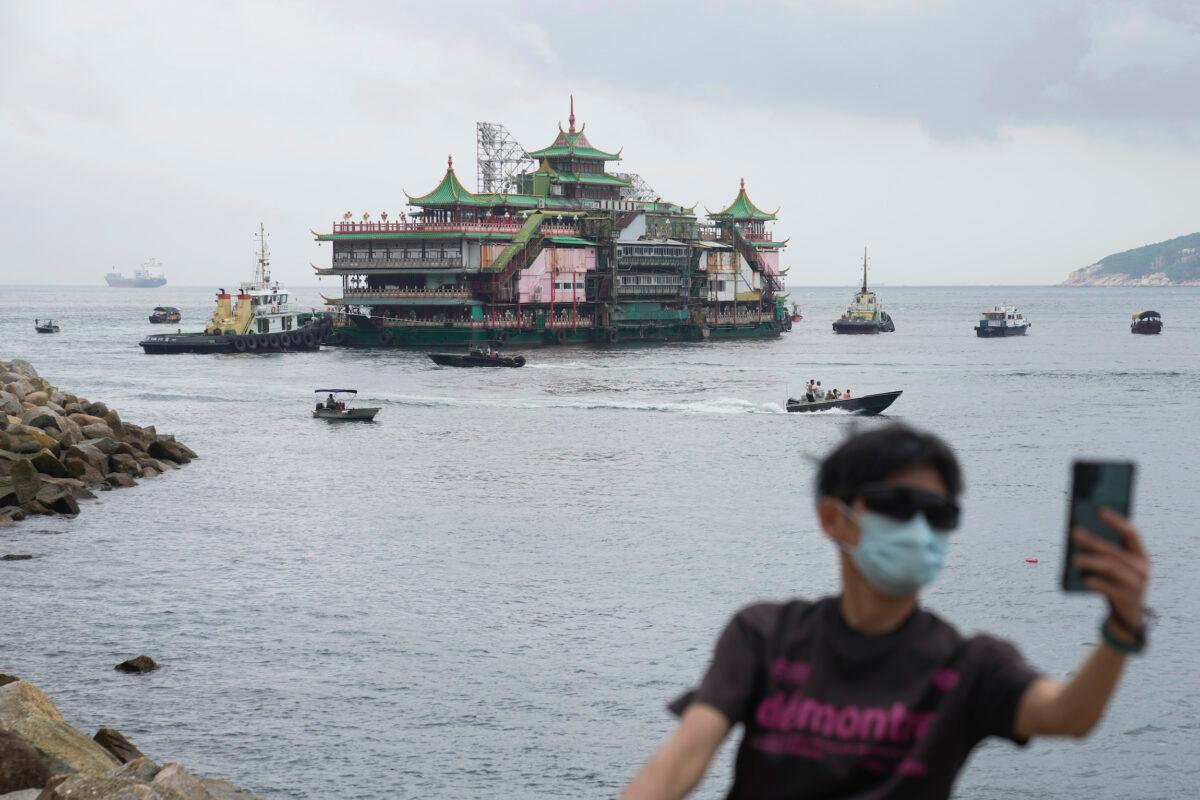 Hong Kong's iconic Jumbo Floating Restaurant is towed away in Hong Kong on June 14, 2022. (Kin Cheung/AP Photo)