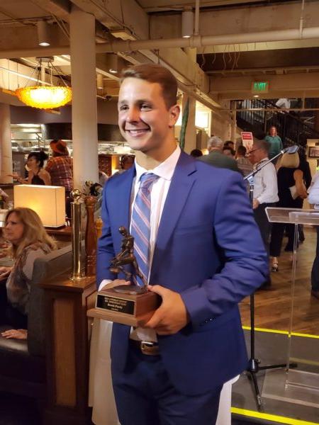 Brock Purdy poses with The Lowsman Trophy for Mr. Irrelevant, for being the final pick in the 2022 NFL draft, at The Cannery restaurant, in Newport Beach, Calif., on June 20, 2022. (Nhat Hoang/The Epoch Times)