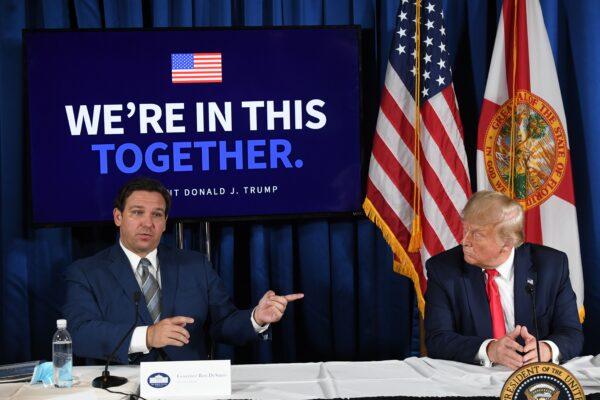 U.S. President Donald Trump and Florida's Gov. Ron DeSantis hold a COVID-19 and storm preparedness roundtable in Belleair, Fla., on July 31, 2020. (Saul Loeb/AFP via Getty Images)