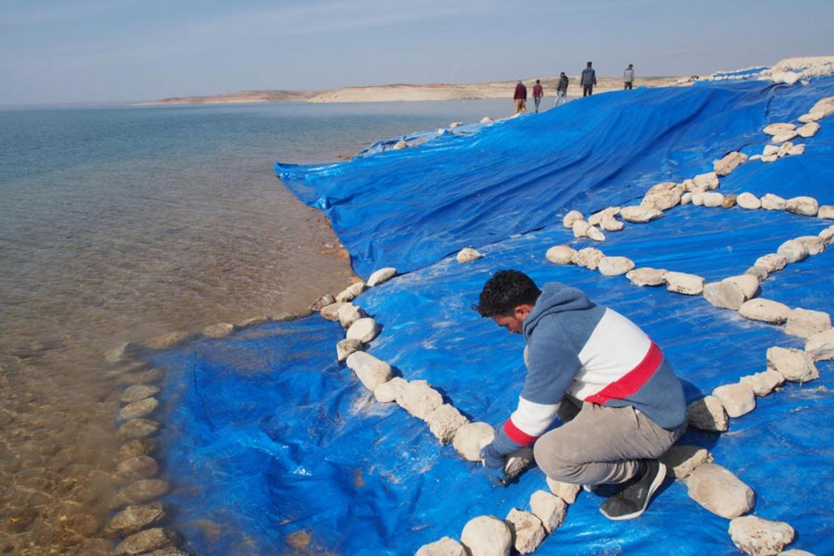  After the research team completed their work, the excavation was covered with plastic sheeting to protect it from the rising waters of the Mosul reservoir. (Courtesy of <a href="https://uni-tuebingen.de/en/university/news-and-publications/press-releases/press-releases/article/a-3400-year-old-city-emerges-from-the-tigris-river/">Universities of Freiburg and Tübingen, KAO</a>)