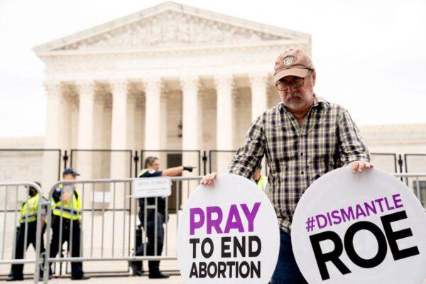 A pro-life demonstrator prays in front of the U.S. Supreme Court in Washington on June 21, 2022. (Stefani Reynolds/AFP via Getty Images)