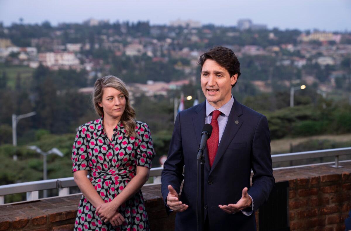 Prime Minister Justin Trudeau responds to questions flanked by Minister for Foreign Affairs Melanie July during a news conference in Kigali, Rwanda, on June 23, 2022. (Paul Chiasson/The Canadian Press)