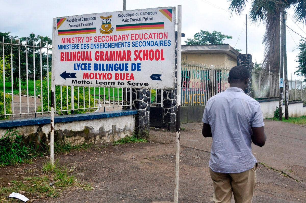 A man walks past the entrance of the bilingual Lycee of Buea, capital of Southwest Cameroon, one of the two regions of the country in the grip of a violent crisis on Sept.24, 2019. (Reinnier Kaze/AFP via Getty Images)